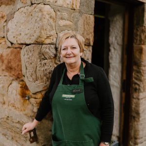 Lady standing outside an old farm shop