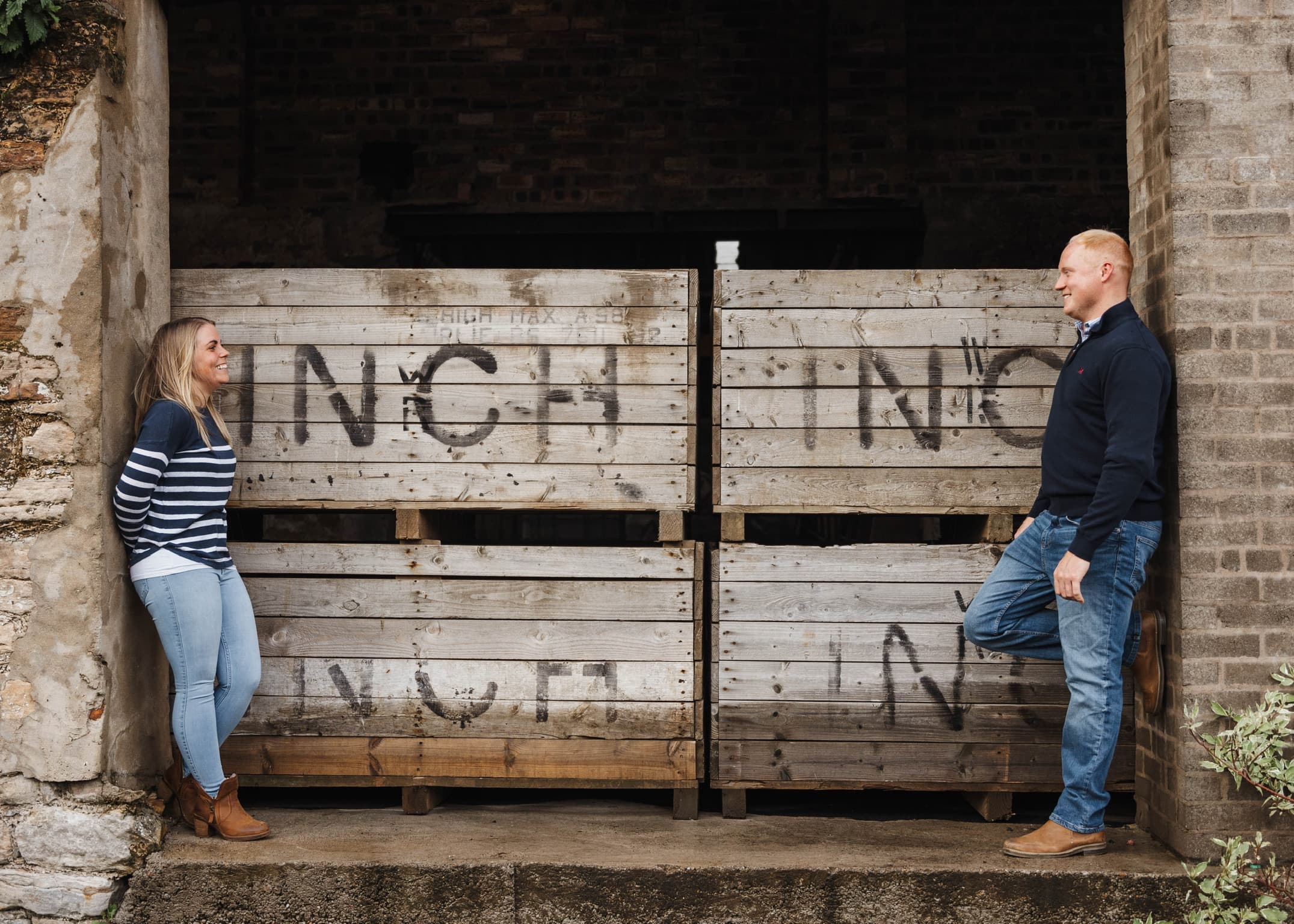 Claire and Matthew standing in front of potato boxes