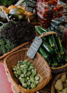 Basket for fresh vegetables. Courgettes, brussels sprouts, kale and strawberries.