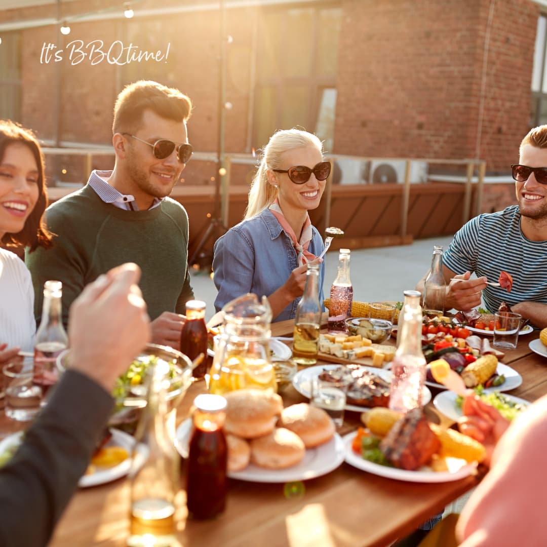 friends sitting around a table having a BBQ
