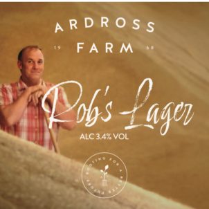 Lager label with picture of a man holding a shovel in his hand standing in a pile of barley.