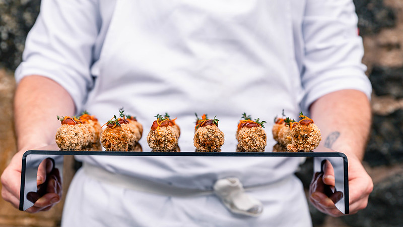 chef holding a tray of canapes