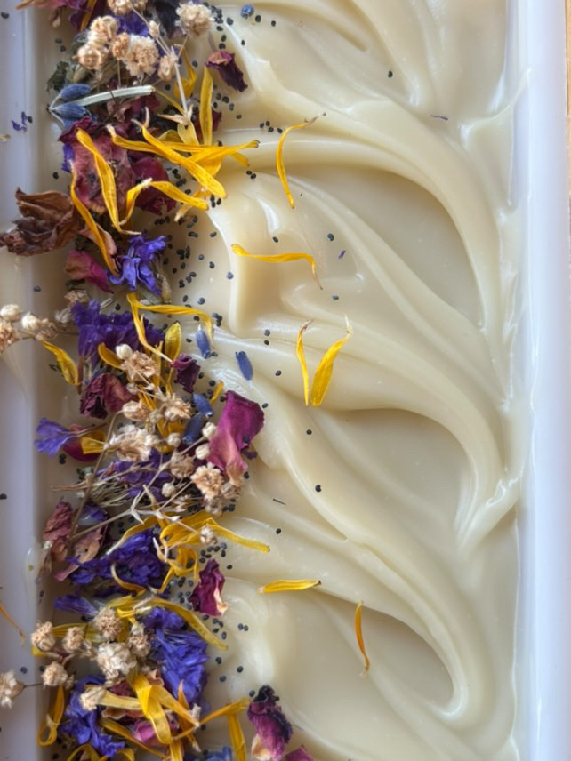 the top of a big slab of wilflower & barley tallow soap showing the wildflowers along the edge