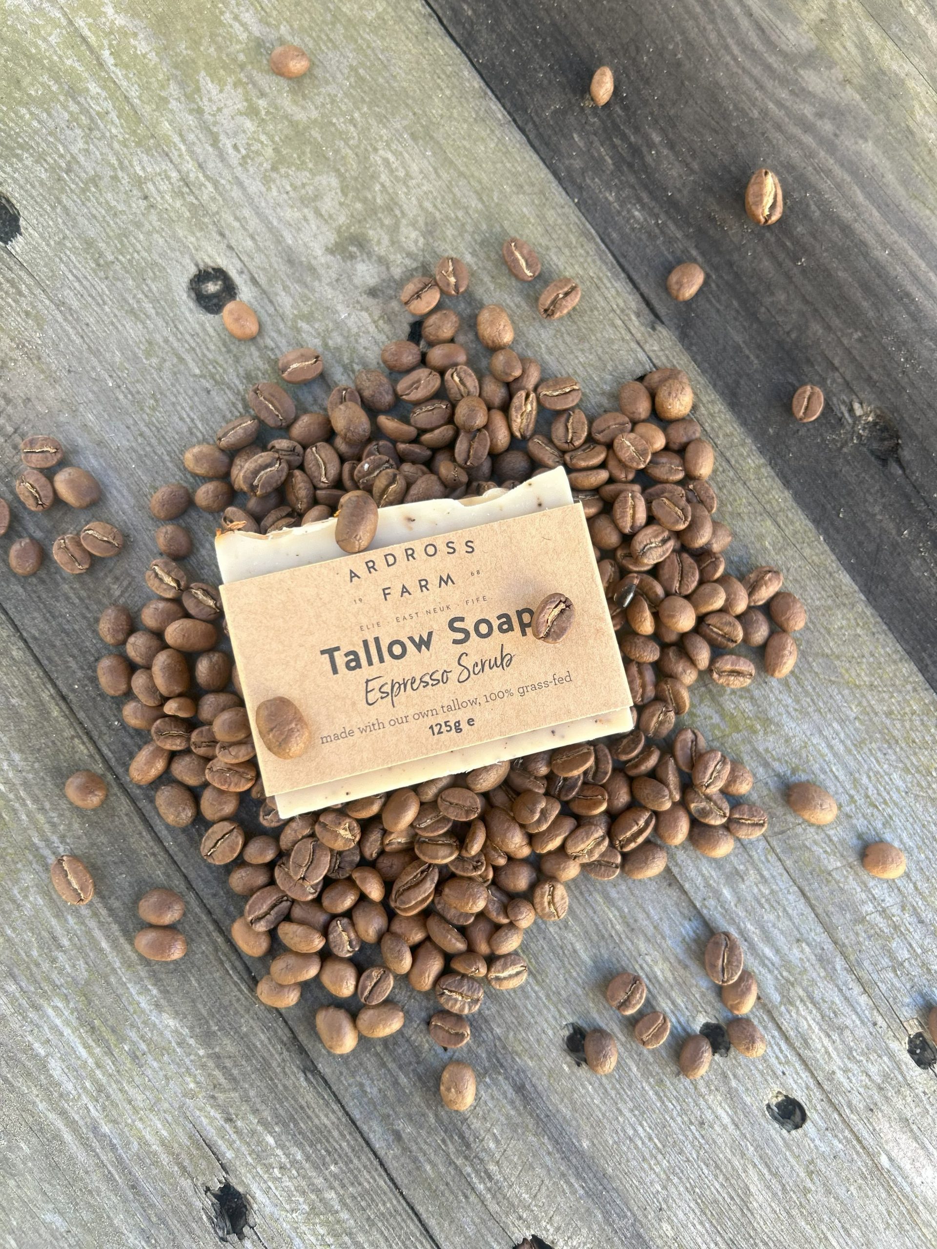 Espresso Scrub Tallow Soap bar of tallow soap lying in espresso beans