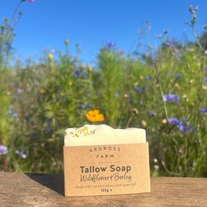 Wildflower tallow soap sitting on wooden table in wildflowers