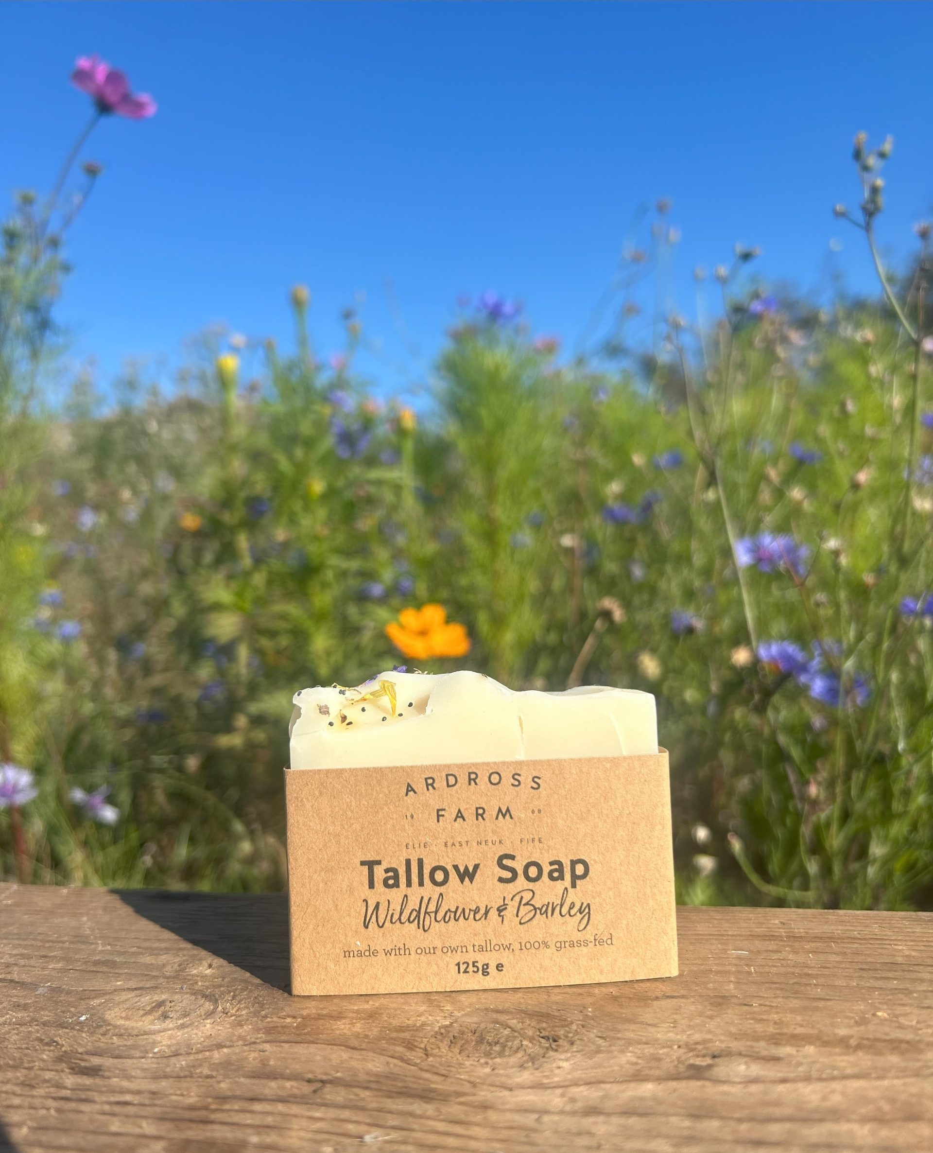 Wildflower tallow soap sitting on wooden table in wildflowers