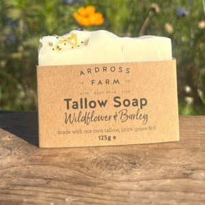 Wildflower tallow soap sitting on wooden table in wildflowers