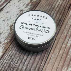 Tin of Tallow Butter sitting on a wooden table