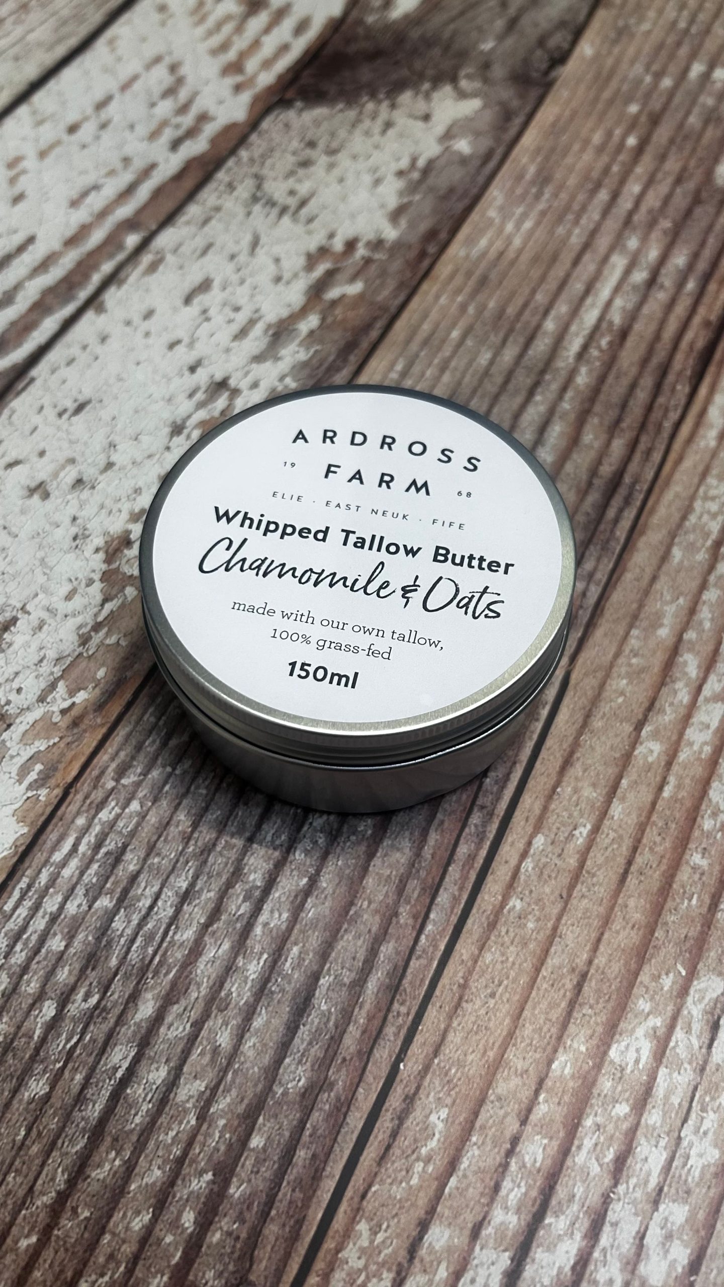 Tin of Tallow Butter sitting on a wooden table