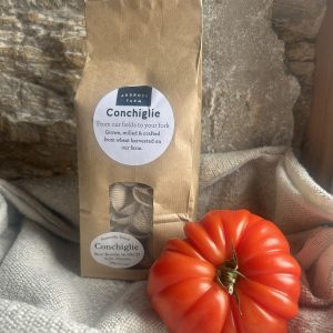 Pasta shells in a brown bag with a beef tomato