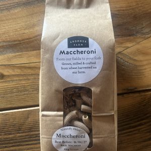 Brown bag of pasta sitting on a wooden table