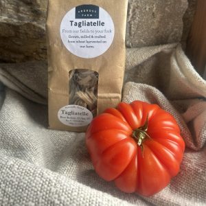 Tagliatelle pasta in a brown bag with beef tomatoes