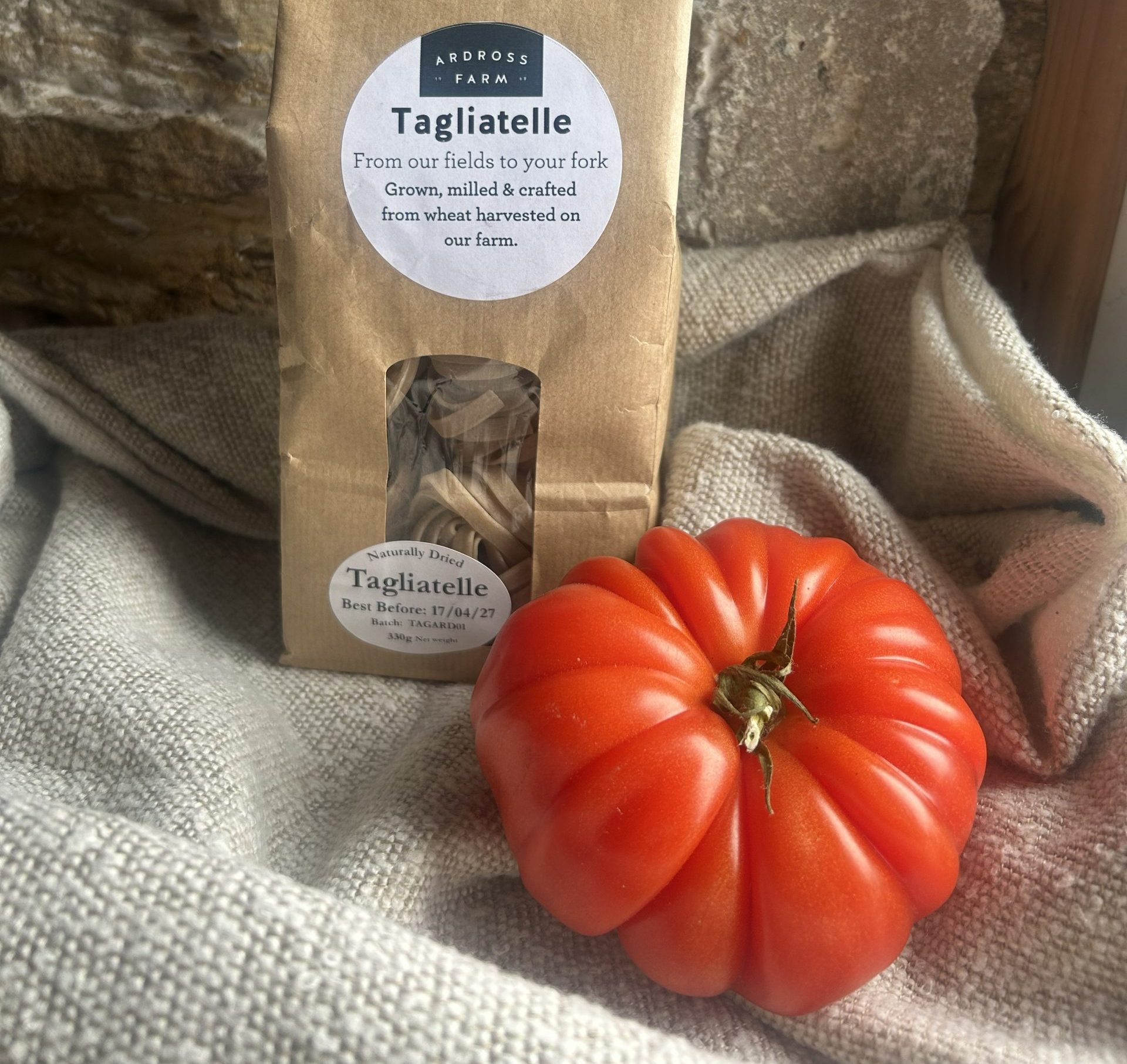 Tagliatelle Tagliatelle pasta in a brown bag with beef tomatoes